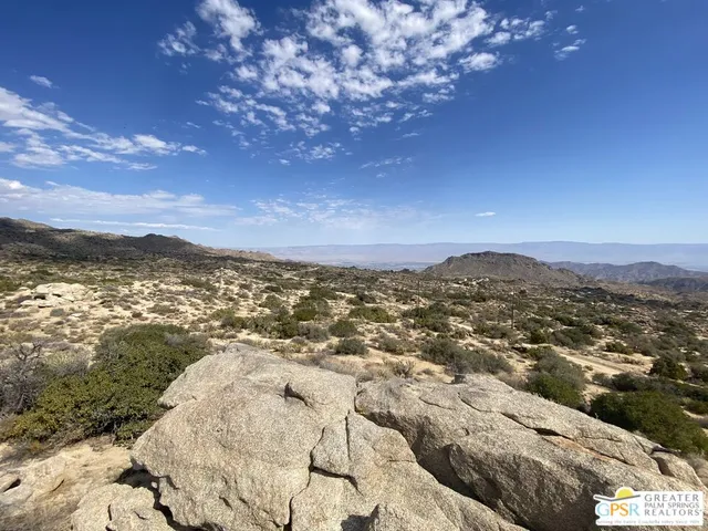a view of a town with mountains in the background