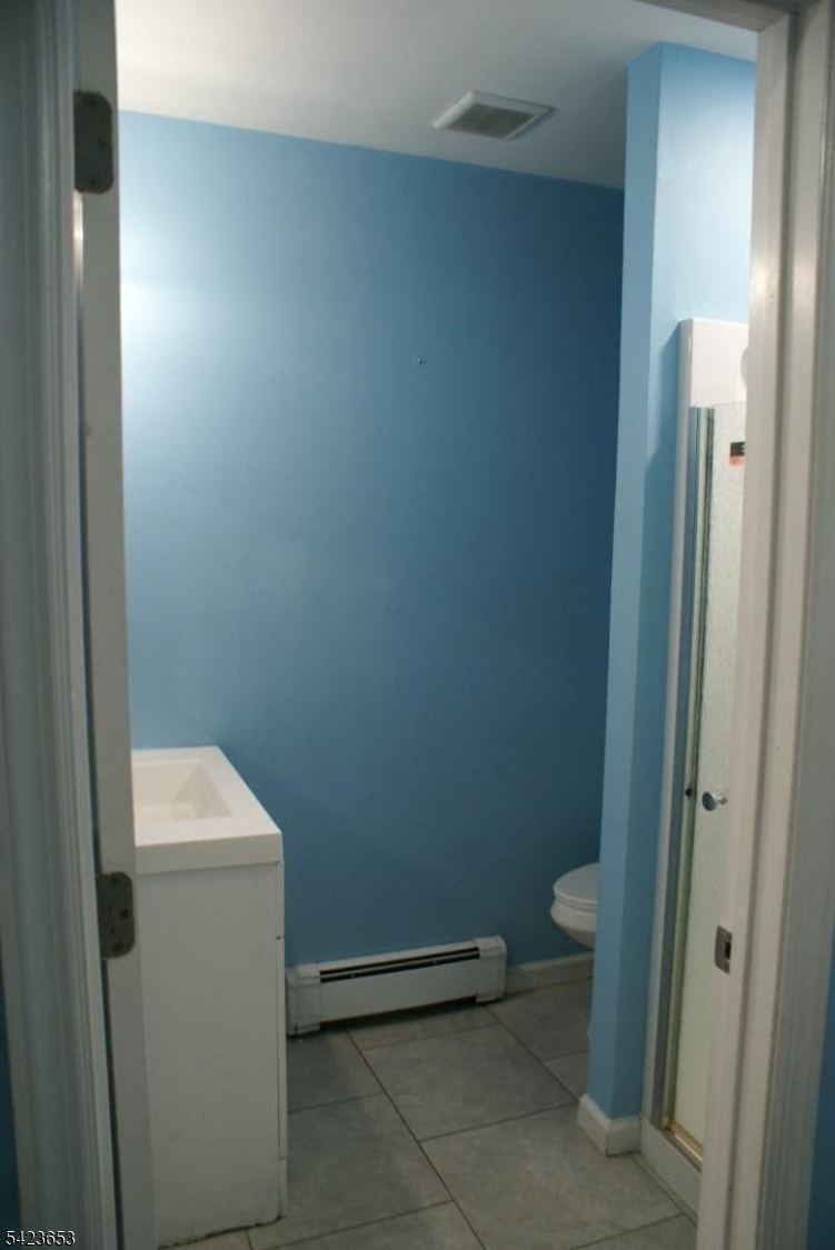 233 Straight Street, Unit 2 Paterson, NJ 07501 - Photo 3 of 9 a bathroom with a sink and toilet