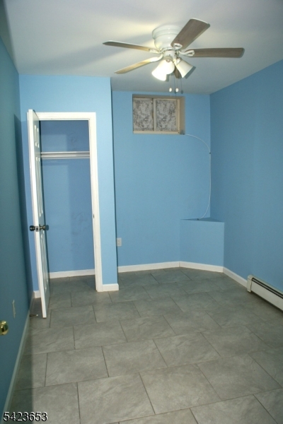 233 Straight Street, Unit 2 Paterson, NJ 07501 - Photo 6 of 9 a view of an empty room with a ceiling fan