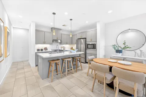 a kitchen that has a sink cabinets counter space and appliances