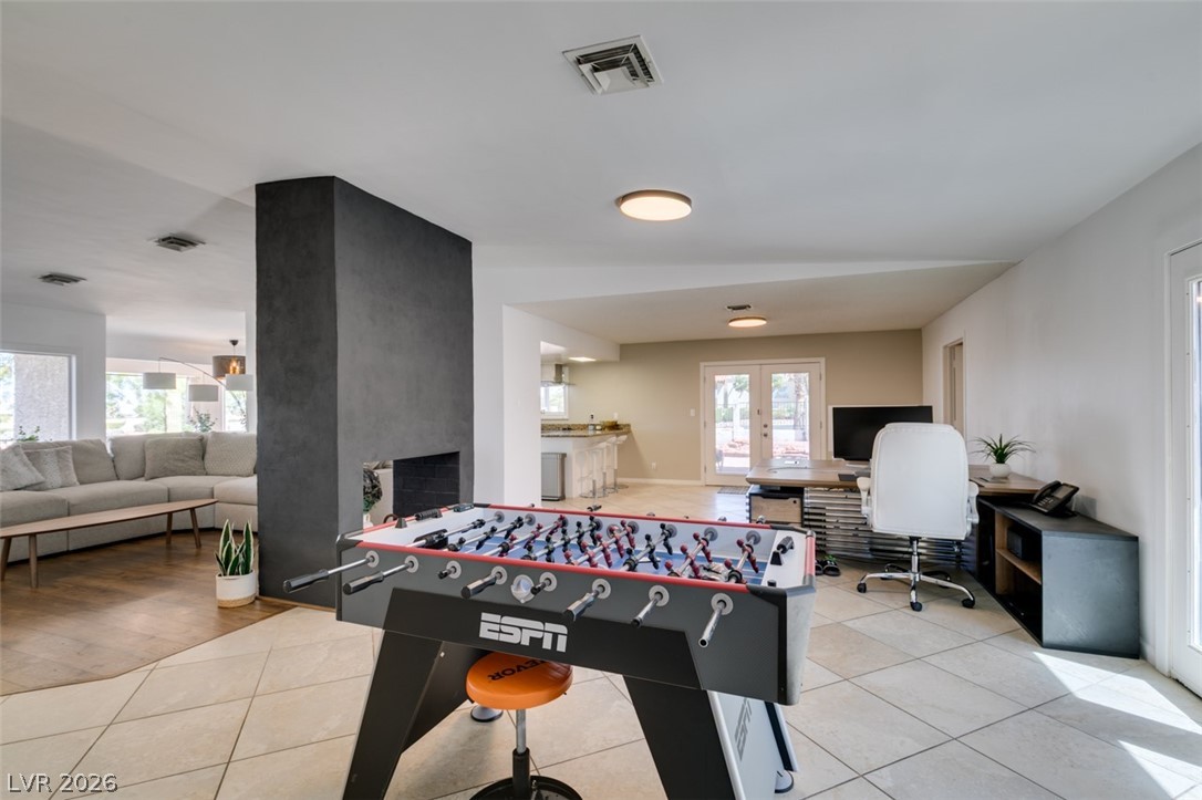 892 North Hollywood Boulevard Las Vegas, NV 89110 - Photo 30 of 81 This versatile living space features an inviting fireplace, perfect for relaxation and entertainment.