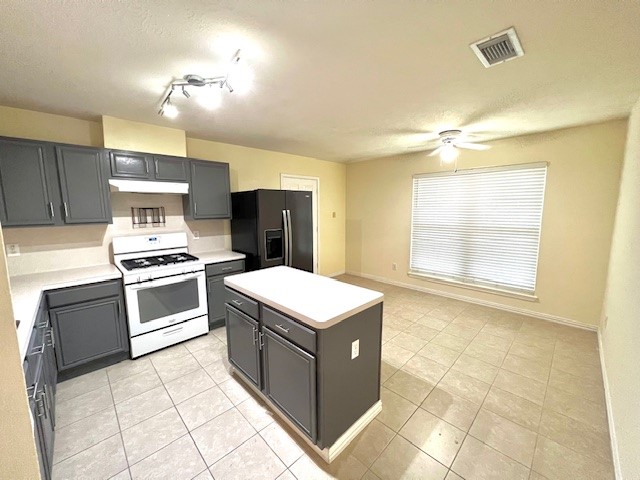 28703 Loddington Street Spring, TX 77386 - Photo 3 of 16 a kitchen with a stove and a refrigerator