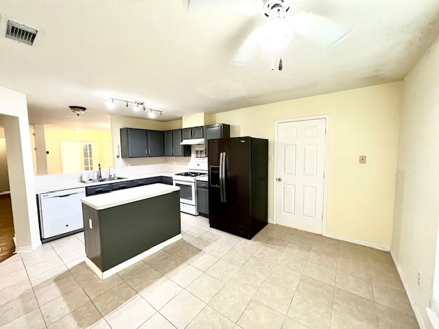 28703 Loddington Street Spring, TX 77386 - Photo 4 of 16 a kitchen with stainless steel appliances a refrigerator sink and cabinets