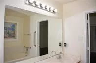 a bathroom with a sink vanity and shower