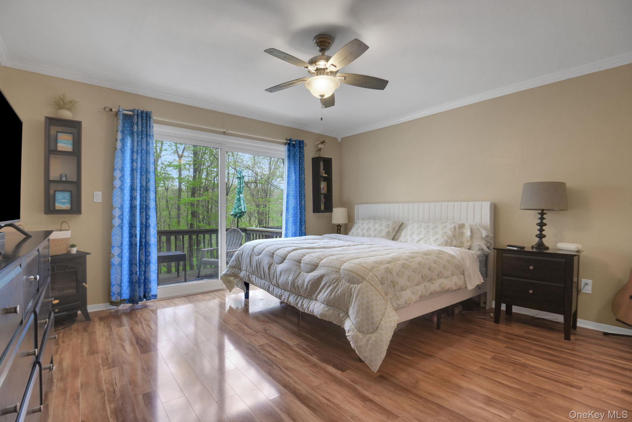 805 Eagles Ridge Road Brewster, NY 10509 - Photo 16 of 22 a spacious bedroom with a large bed and a chandelier