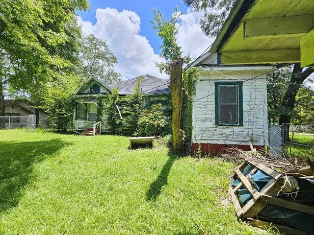 a view of backyard with a garden and outdoor seating