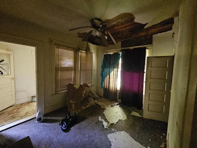 a room with gym equipment and a glass door shower