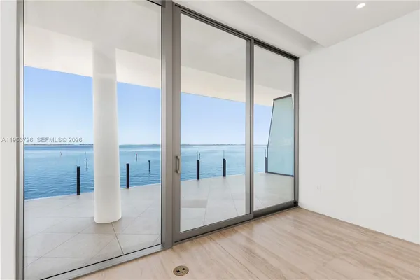 a room with a large bed and a chandelier