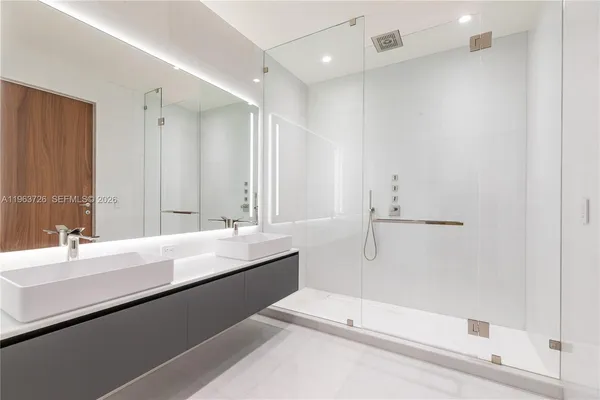 a bathroom with a bathtub a sink and a mirror