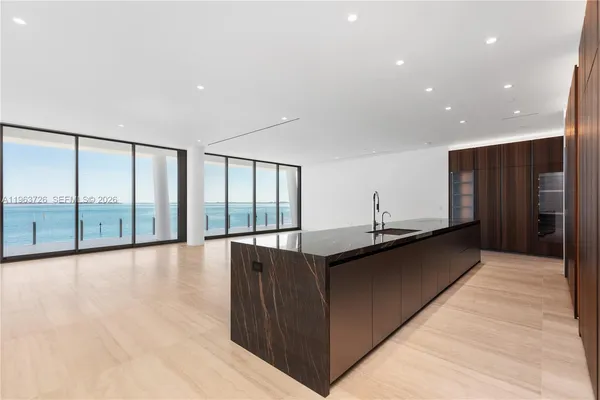 a view of a kitchen with a sink and cabinets
