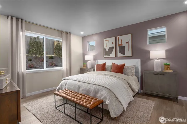 a bedroom with a bed and a large window