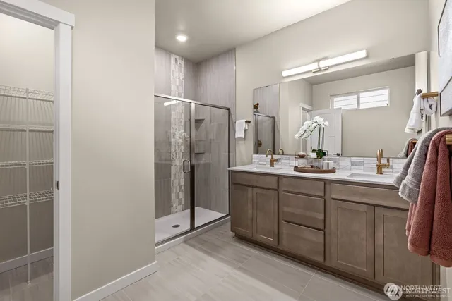 a bathroom with a double vanity sink and mirror