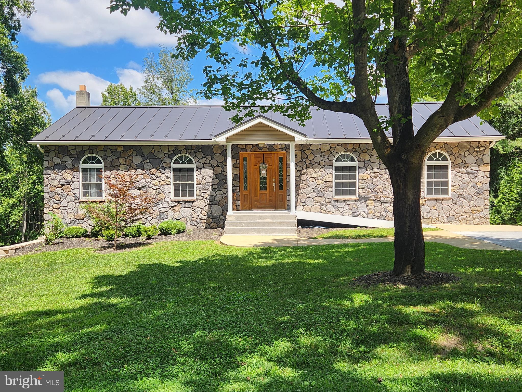 a front view of a house with garden
