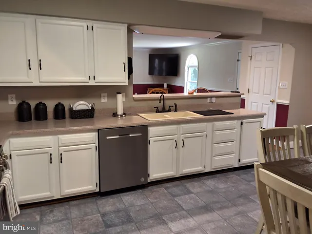 a kitchen with white cabinets
