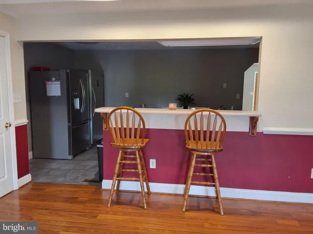 a view of a chairs room with wooden floor