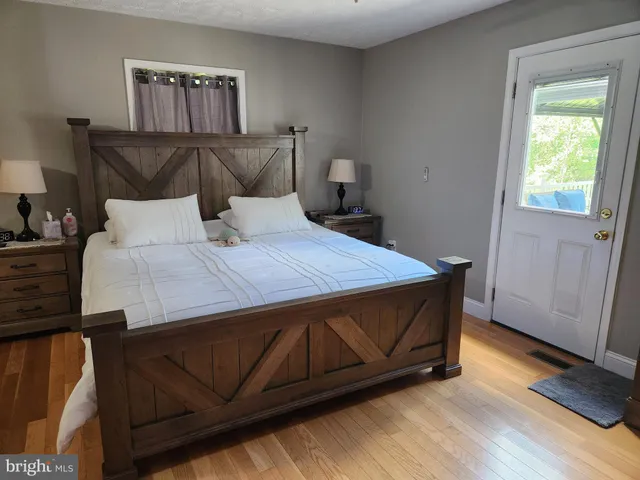 a bed sitting in a bedroom next to a window