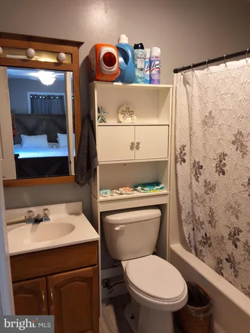 a bathroom with a toilet sink and shower