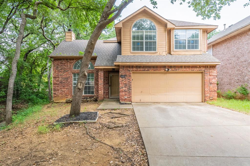 1405 Timber Creek Road Flower Mound, TX 75028 - Photo 1 of 1 Traditional-style house with driveway, brick siding, an attached garage, a shingled roof, and a chimney