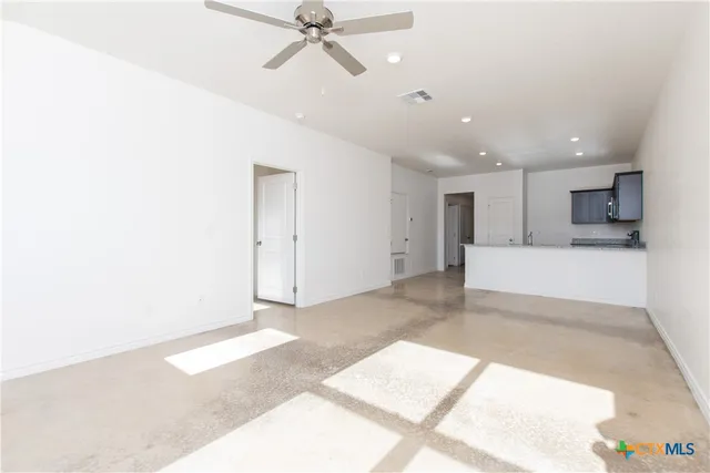 a view of a kitchen with a sink and a window