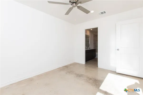 a view of an empty room with a ceiling fan