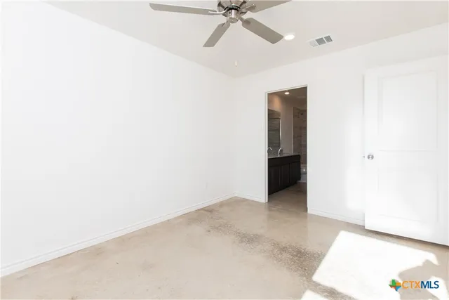 a view of an empty room with a ceiling fan