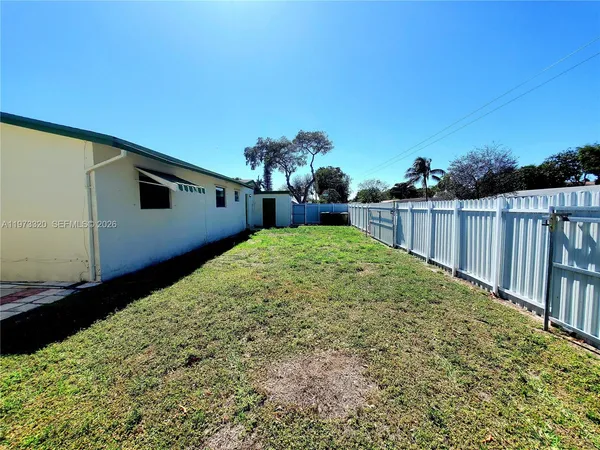 a backyard of a house with large trees