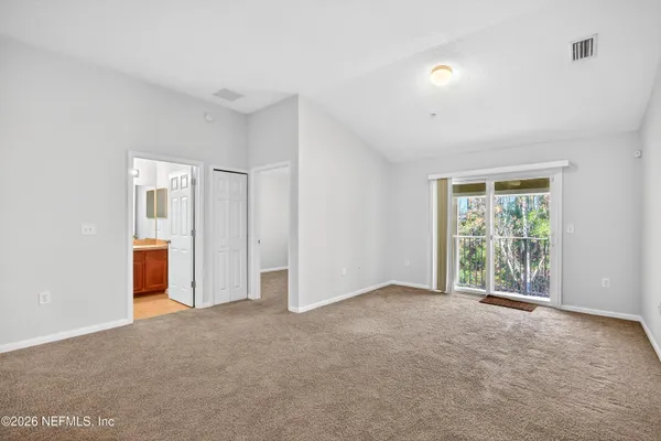 a view of an empty room with a window