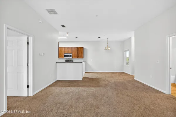 a view of a kitchen with a sink and a refrigerator