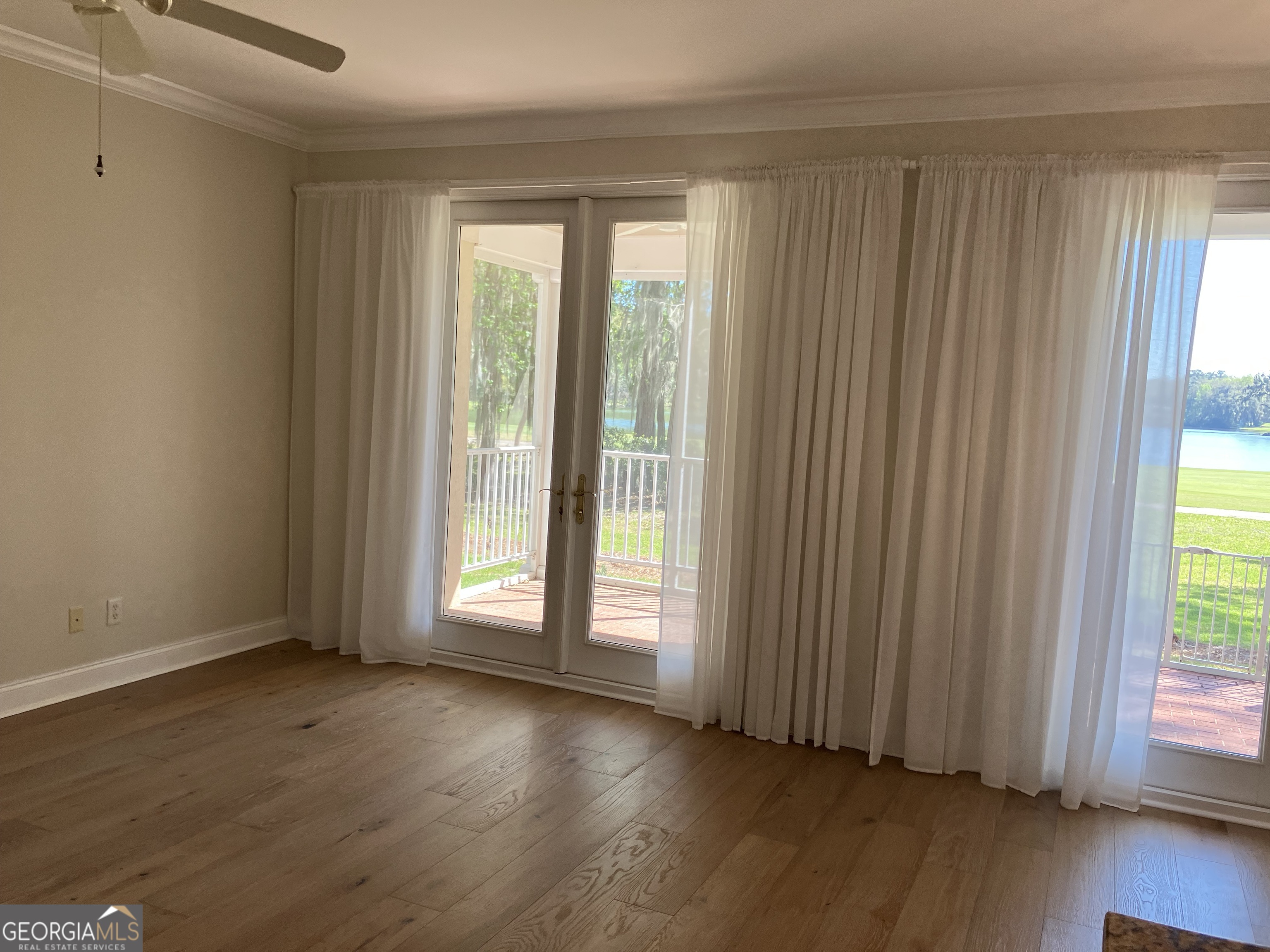 103 Kiln Trail St. Simons Island, GA 31522 - Photo 26 of 81 an empty room with wooden floor and windows