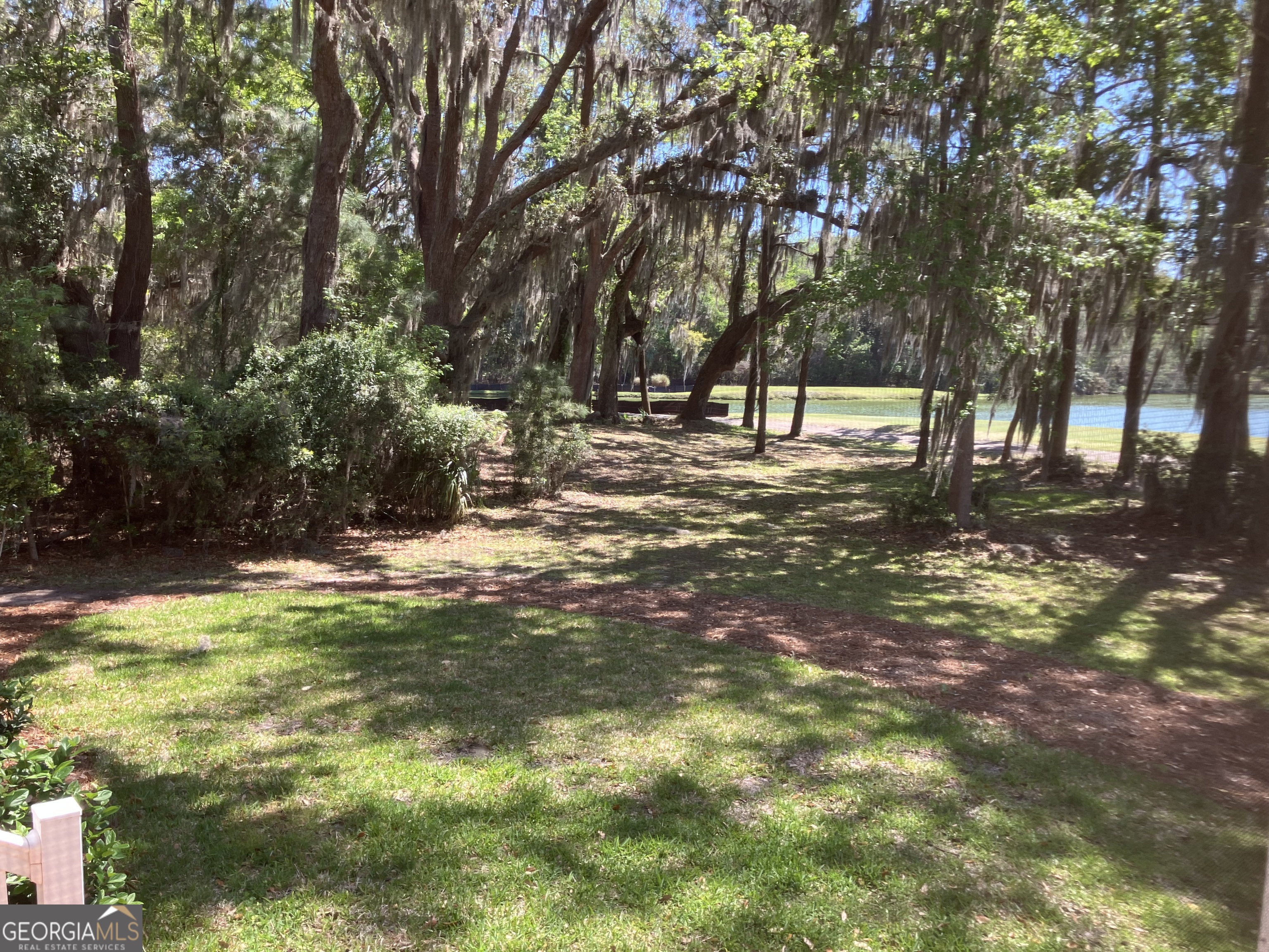 103 Kiln Trail St. Simons Island, GA 31522 - Photo 36 of 81 a backyard of a house with lots of green space