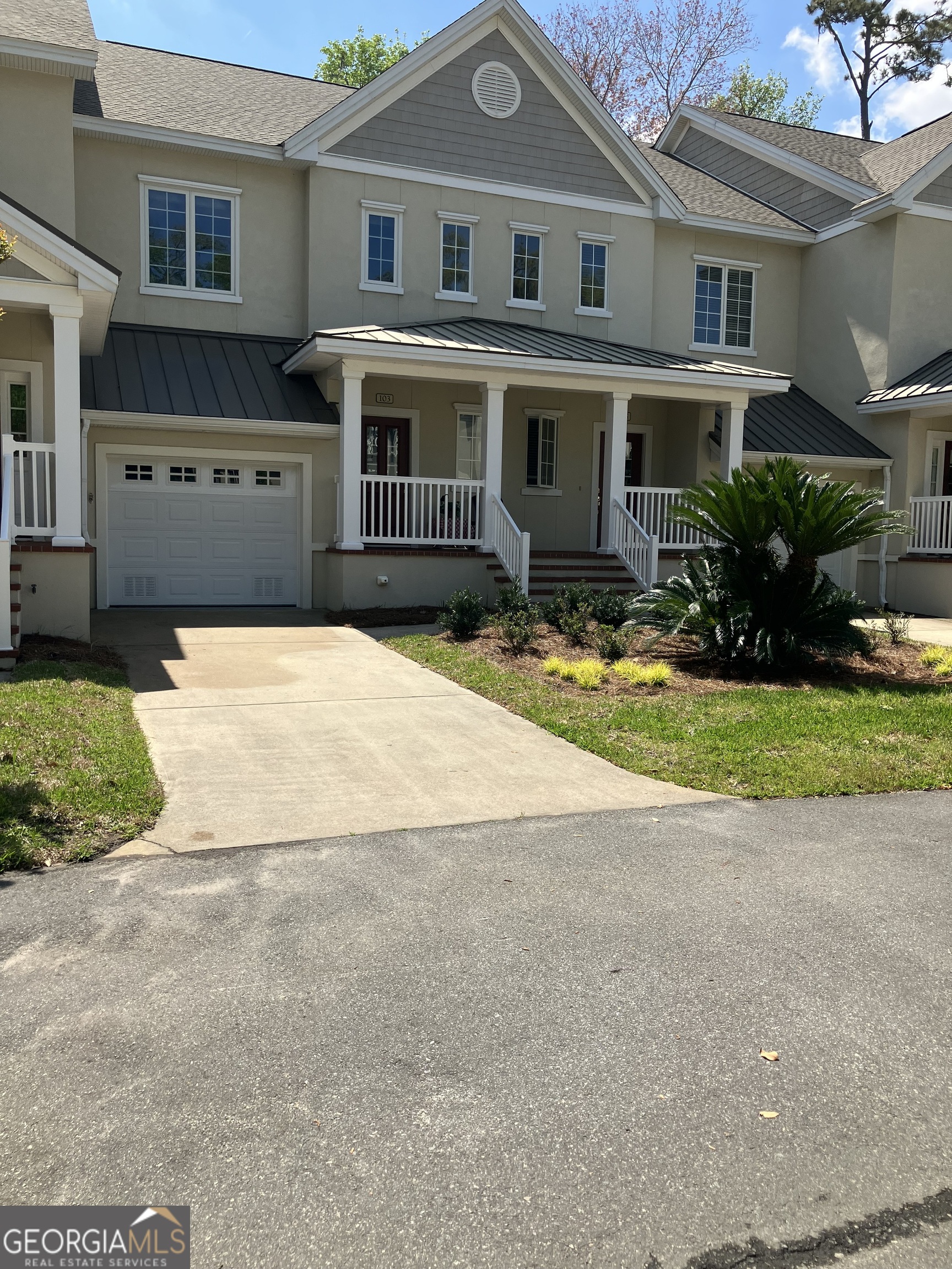 103 Kiln Trail St. Simons Island, GA 31522 - Photo 4 of 81 a front view of a house with a yard and garage