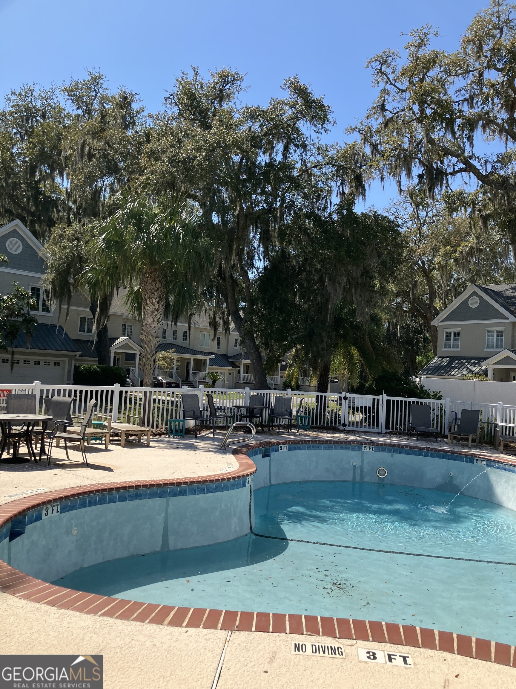 103 Kiln Trail St. Simons Island, GA 31522 - Photo 78 of 81 a view of swimming pool with outdoor seating and trees