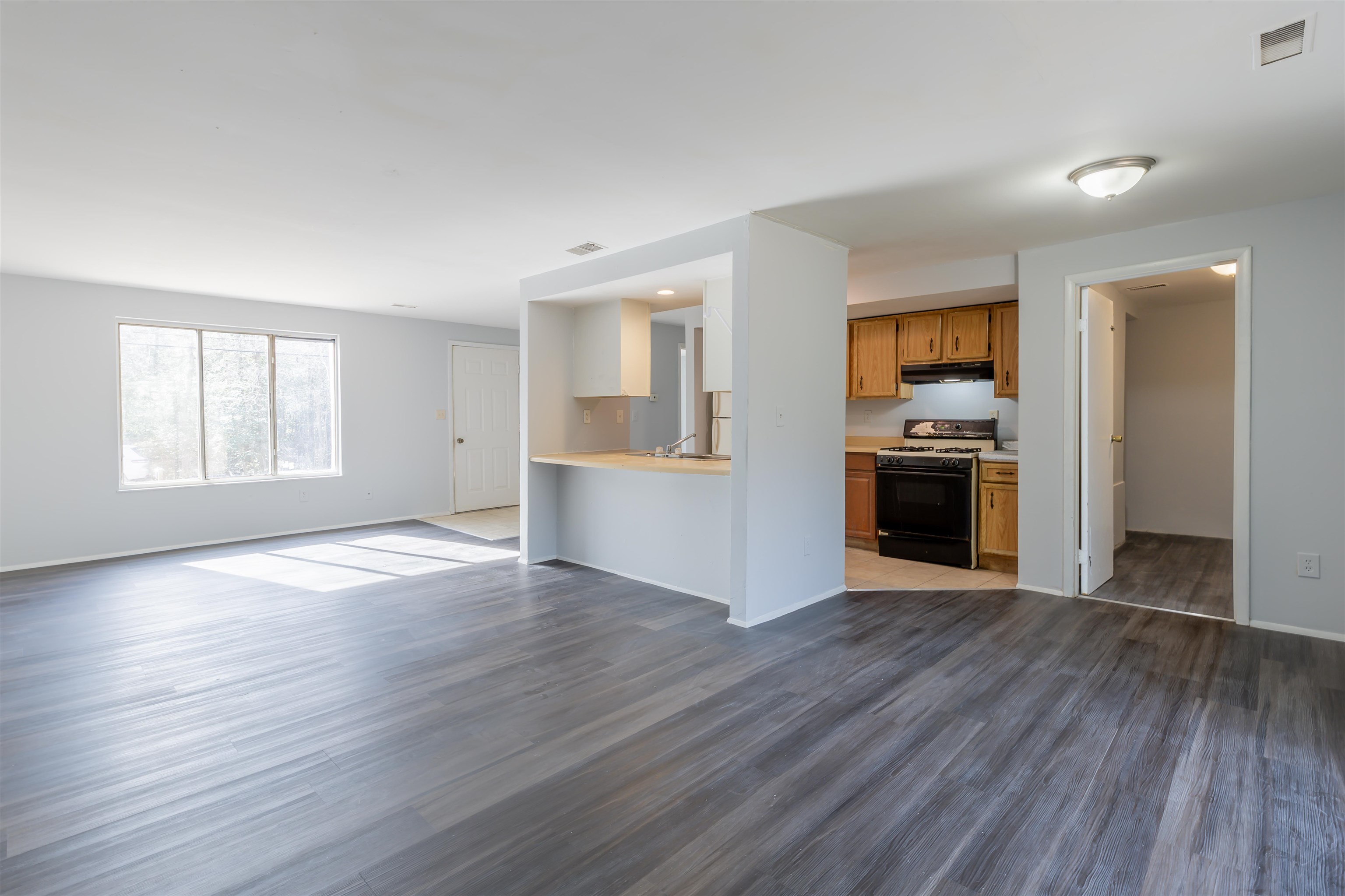 900 East Main Street Rio Grande, NJ 08242 - Photo 6 of 29 an empty room with wooden floor kitchen view and a window