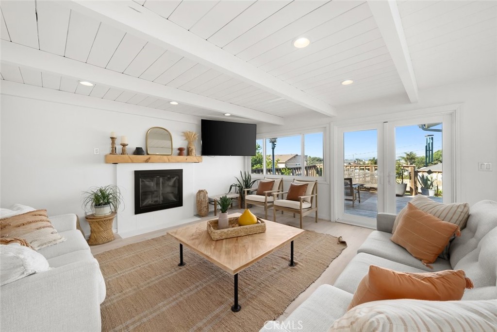 363 North 5th Street Grover Beach, CA 93433 - Photo 13 of 54 a living room with furniture a fireplace and a view of kitchen