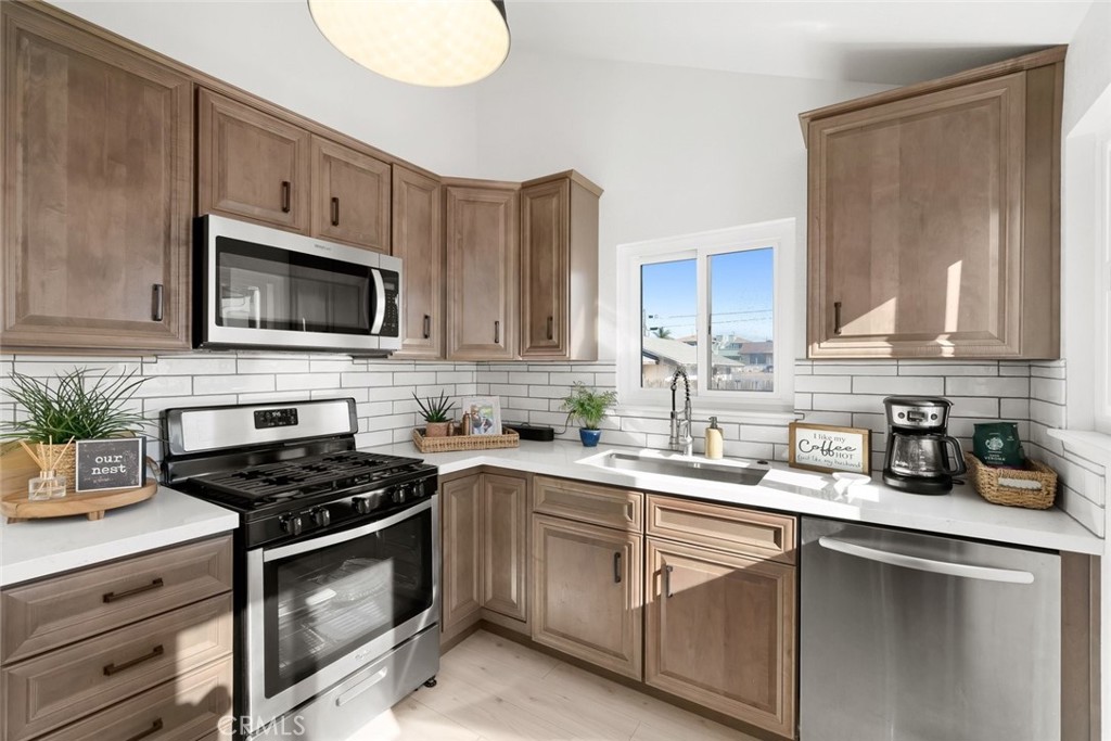363 North 5th Street Grover Beach, CA 93433 - Photo 19 of 54 a kitchen with cabinets stainless steel appliances a sink and a microwave