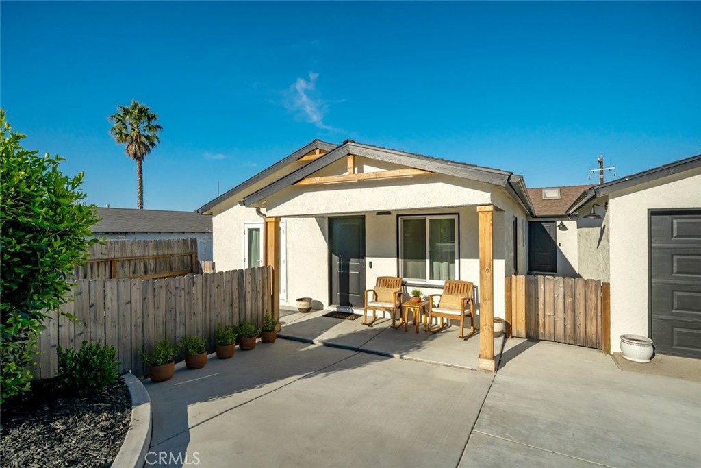 363 North 5th Street Grover Beach, CA 93433 - Photo 4 of 54 a patio with a table and chairs and potted plants