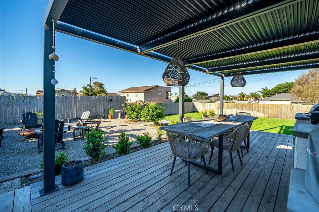 363 North 5th Street Grover Beach, CA 93433 - Photo 45 of 54 a view of a patio with table and chairs potted plants with wooden floor