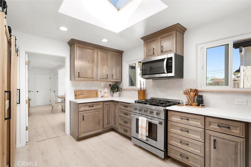 363 North 5th Street Grover Beach, CA 93433 - Photo 9 of 54 a kitchen with a sink stove and cabinets