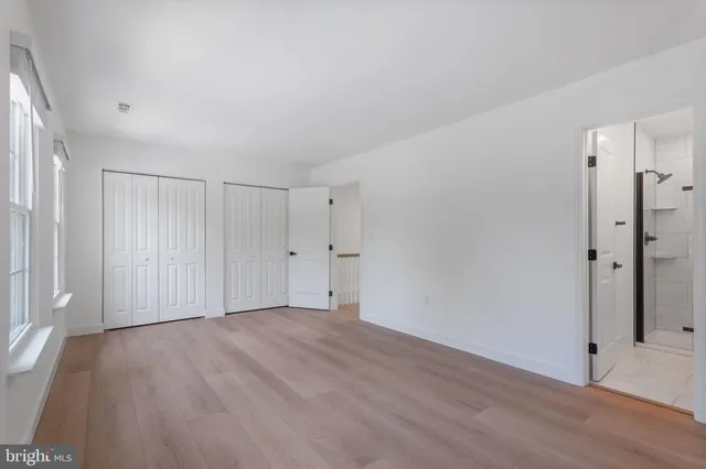 a view of an empty room with wooden floor