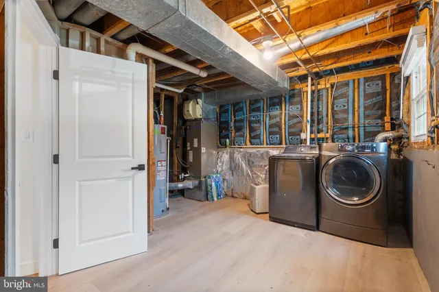 a view of a storage and utility room with washer and dryer