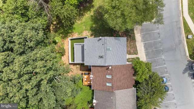 an aerial view of residential house with outdoor space and trees all around