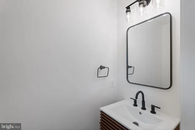 a bathroom with a sink and mirror