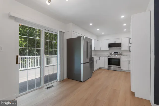 a kitchen with granite countertop a refrigerator and a sink