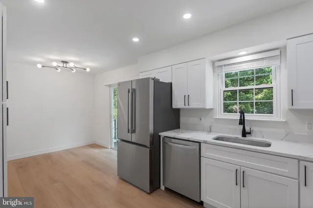 a kitchen with refrigerator and window