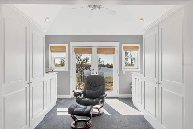 a view of a workspace with furniture and a flat screen tv