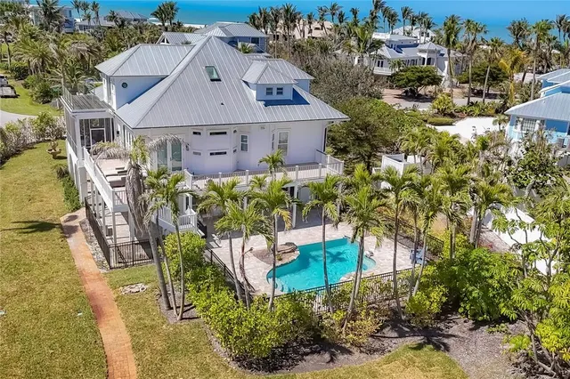 an aerial view of a house with a yard and sitting area
