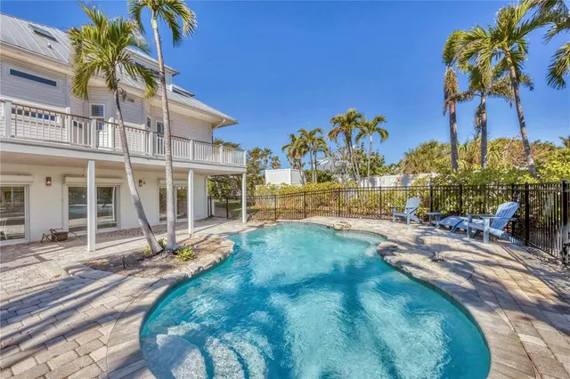 a view of a palm trees front of house