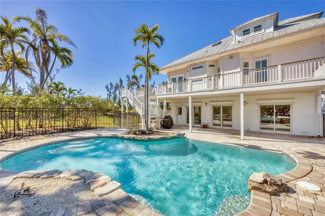 a view of house with outdoor space and swimming pool