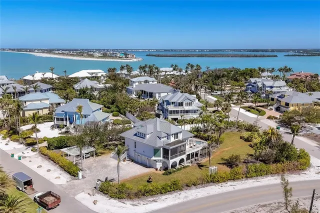 an aerial view of a house with a yard and lake view