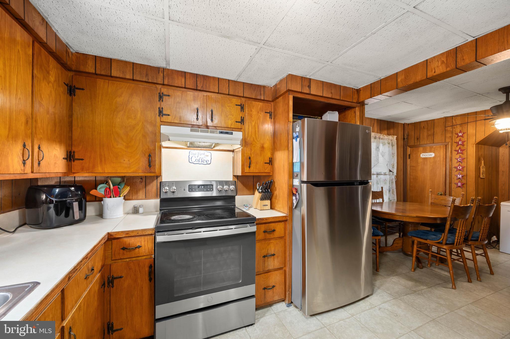 26467 Mariners Road Crisfield, MD 21817 - Photo 23 of 44 a kitchen with stainless steel appliances a refrigerator and a sink